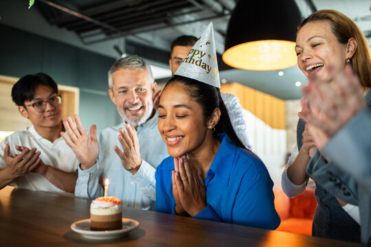 Coworkers celebrate a birthday in modern office