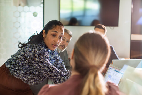 Businesswoman leading team discussion in office conference room