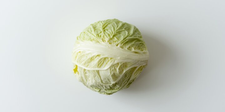 Whole green cabbage on a white background