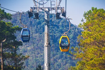 Cable car ropeway cabins in cableway above forest in the mountains in Dalat city in Vietnam in Asia © alexkoral