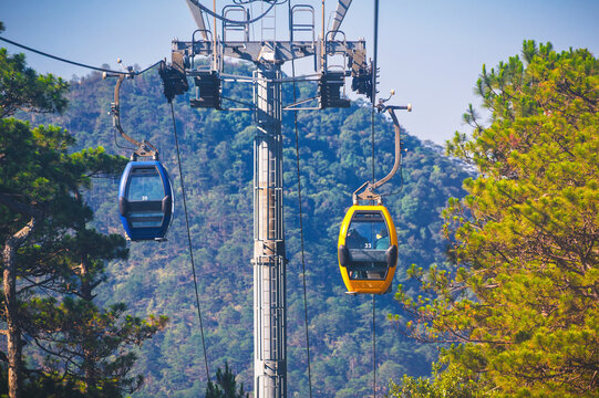 Cable car ropeway cabins in cableway above forest in the mountains in Dalat city in Vietnam in Asia