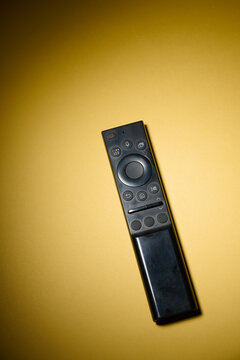 Close-up of a television remote control resting on a table.