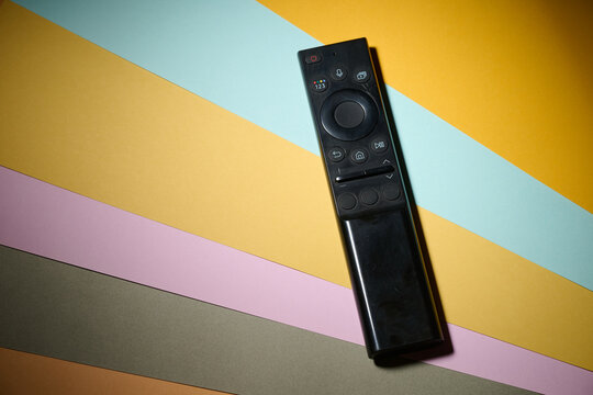 Close-up of a television remote control resting on a table.