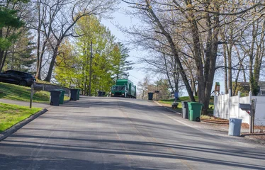 trash collecting truck on residential street © nd700