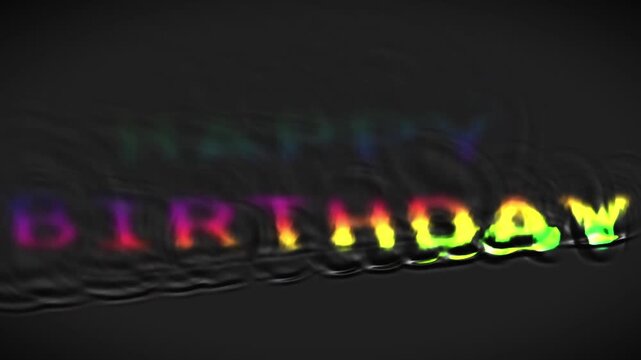 Happy birthday text appearing in colorful liquid