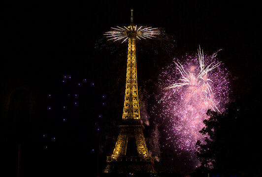 A star shaped firework burst lights the sky beside the Eiffel Tower in Paris France July 13 2026