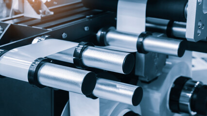 Obraz premium Fragment of the conveyor of sticking labeling machine. tech industrial technology background