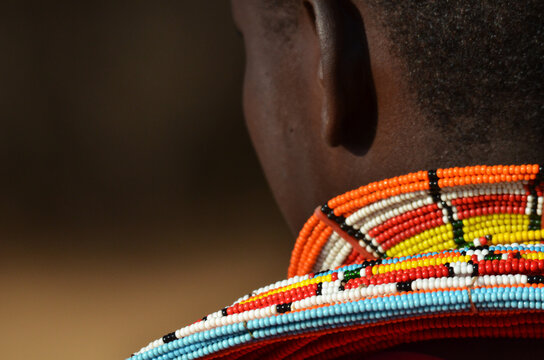 Kenya, Laikipia, Il Ngwesi, Masai man wearing traditional clothes and adorned with elaborate beadwork jewellery