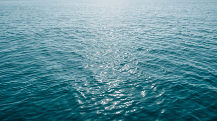Obraz premium Blue ocean water surface. Rippling sea waves reflecting bright sunlight.