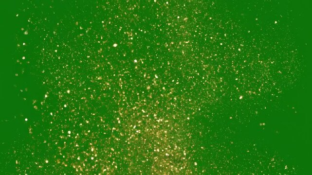 Golden glitter particles cascade down against a vibrant green background, creating a mesmerizing visual effect that enhances festive celebrations and joyful occasions