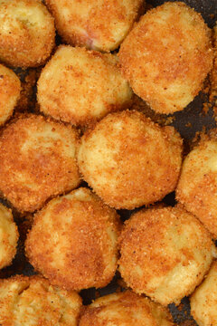 A macro shot of traditional sweet potato dumplings coated in golden fried breadcrumbs known as knedle in central and eastern Europe.