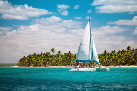 Catamaran sailing boat with tourists in turquoise water near Saona Island Dominican republic
