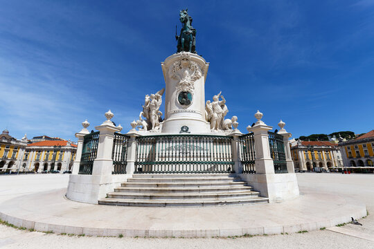 Imposing equestrian statue of King Jose I dominates the Comercio square in Lisbon, Portugal its white marble pedestal richly decorated with Baroque allegorical figures, winged horses, and a royal