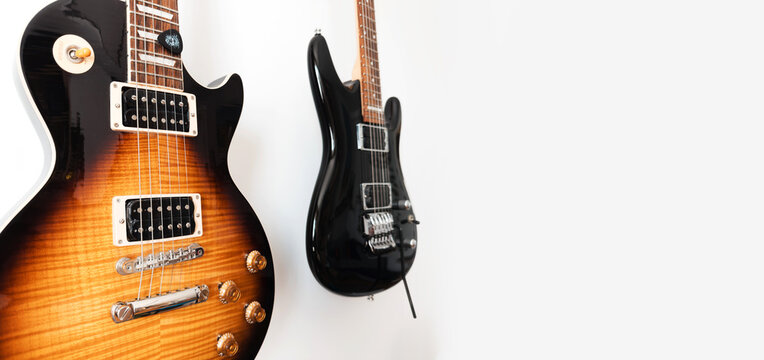 May 11, 2026, Częstochowa, Poland - Gibson and Ibanez Electric Guitars Hanging on White Wall