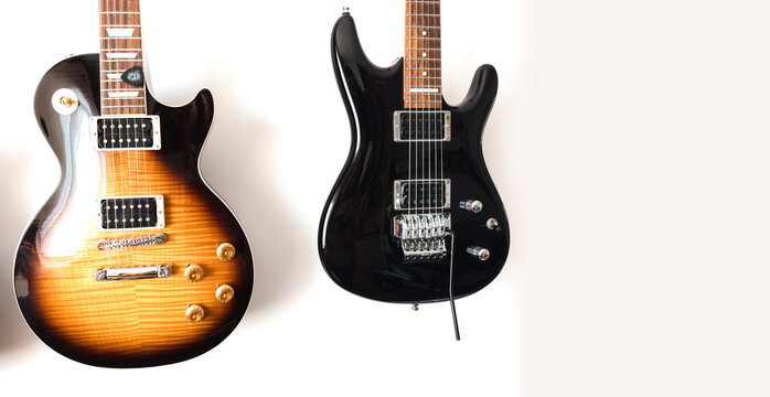 May 11, 2026, Częstochowa, Poland - Gibson and Ibanez Electric Guitars Hanging on White Wall