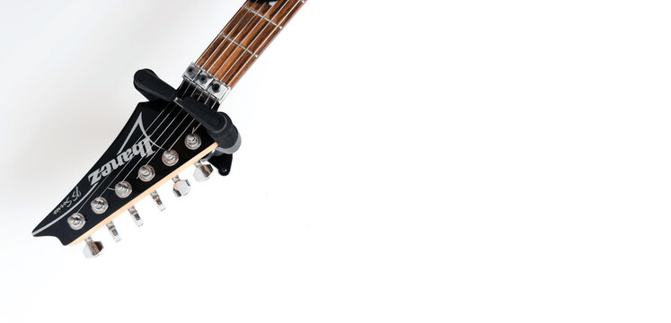 May 11, 2026, Częstochowa, Poland - Gibson and Ibanez Electric Guitars Hanging on White Wall