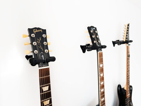May 11, 2026, Częstochowa, Poland - Gibson and Ibanez Electric Guitars Hanging on White Wall
