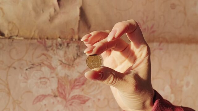 Woman Holding Vintage Soviet Two Kopeck Coin from 1969 in Retro Sunlight Closeup