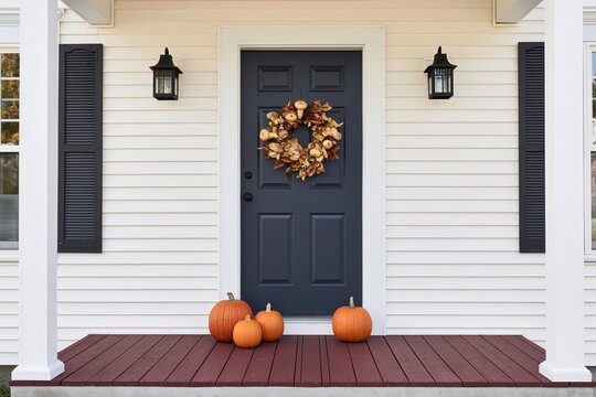The Blue Front Door with Harvest Wreath and Pumpkin Display on Porch