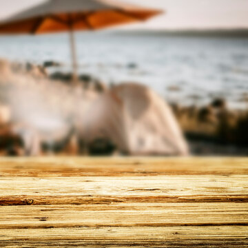 Wooden table with copy space and blurred summer barbecue background