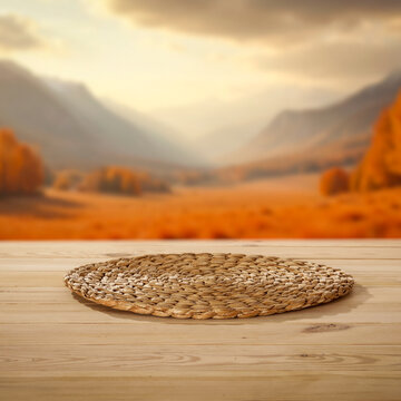 Empty wooden table with clean copy space for product placement. Blurred background of picturesque mountain meadow in late summer or autumn with distant mountains.