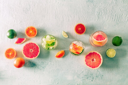 Refreshing summer cocktails with ice cubes on a light background