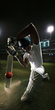 Cricket batter kneeling during powerful low defensive shot on illuminated stadium field. Concept of defensive play, professional cricket, sports competition, advertising and tournament promotion.