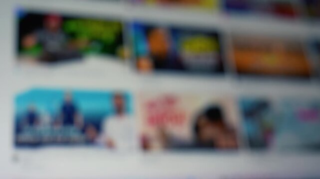 Blurred view of photo thumbnails arranged in rows on a screen or wall, creating a soft abstract background