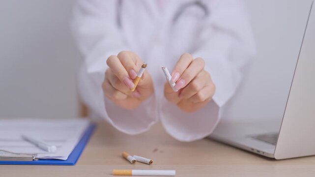 doctor hand making stop sign to refuse and breaking cigarette, quitting smoking for healthy lungs, prevent Lung Cancer and Emphysema, World No Tobacco Day concept
