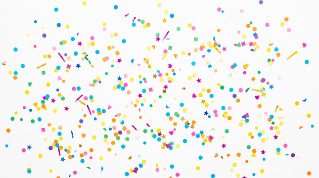 Colorful confetti falling on white background. Festive party paper decoration.
