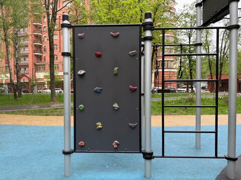 Outdoor kids climbing wall at playground in residential area