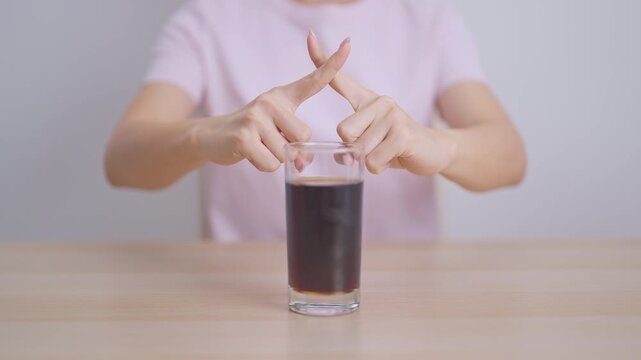 Healthy woman hand stop sign to refuse soft drink and soda, say no to sugar and carbonated beverage, healthy lifestyle, Acid reflux, Heartburn and Gastritis concept