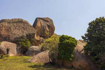 Isolated balancing rock boulder sitting on top of a grassy hill © Hans Malm
