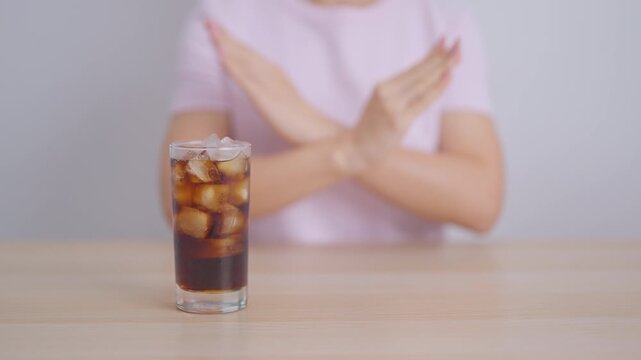 Healthy woman hand stop sign to refuse soft drink and soda, say no to sugar and carbonated beverage, healthy lifestyle, Acid reflux, Heartburn and Gastritis concept