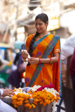 Happy woman buying flowers from street shop