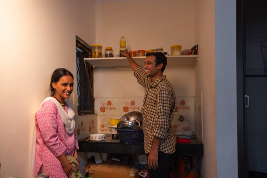 Husband helping his wife with housework in the kitchen