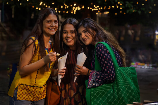 women having fun and eating Jhalmuri on street