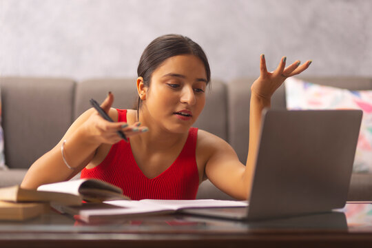 Portrait of a teenage girl having online class at home