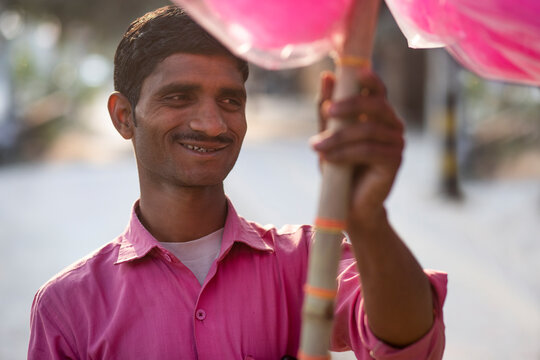 Male vendor selling cotton candy on the street