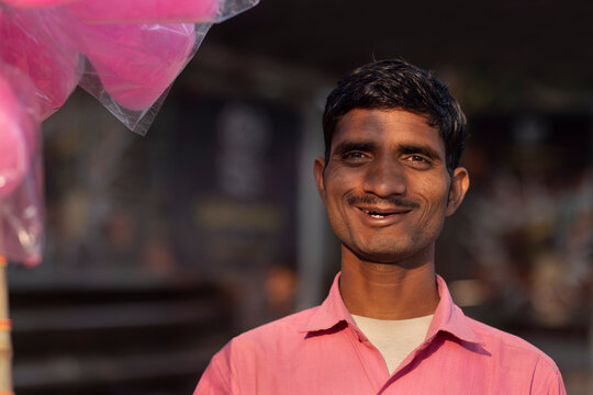 Male vendor selling cotton candy on the street