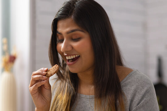 Close-up portrait of woman eating cookies