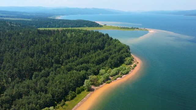 Shiroka Polyana reservoir scenic aerial drone view crystal water lake green pine forest shoreline beach blue sky summer landscape Rhodope mountains Western Rhodopes Bulgaria eco tourism concept.