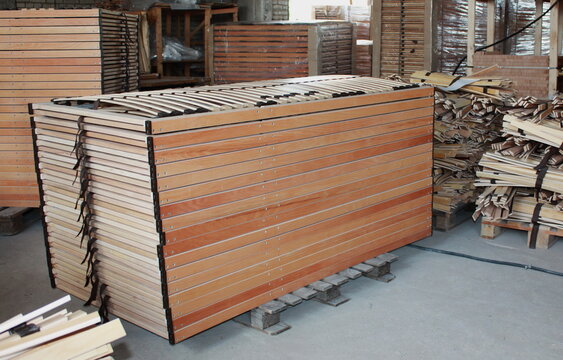 Stacked wooden slats for orthopedic bed bases in a busy production workshop