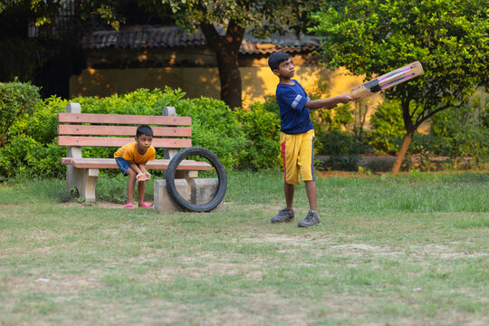 Portrait of boy playing cricket in the park
