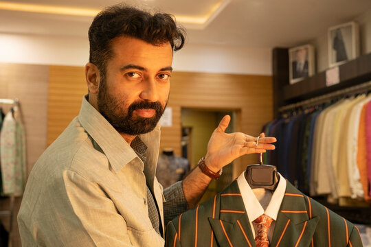 Buyer checking jackets in a bespoke clothing store 