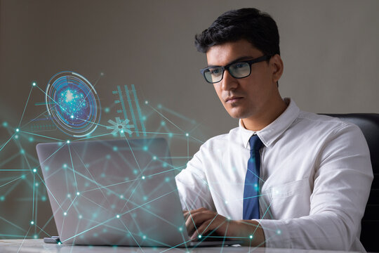 Businessman working on laptop computer with icons on virtual screen