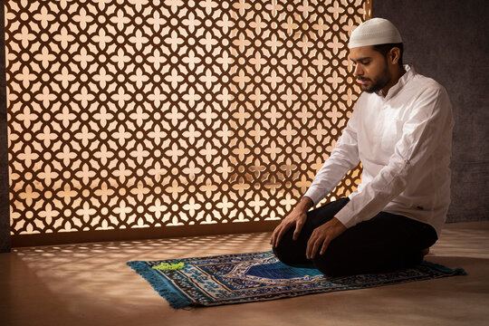 Portrait of a Muslim man praying at home