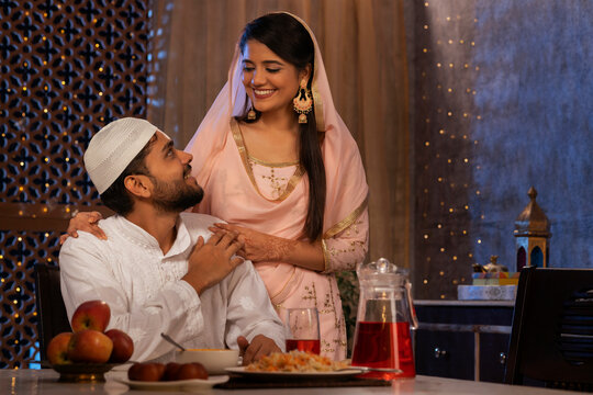 Portrait of happy Muslim couple looking at each other