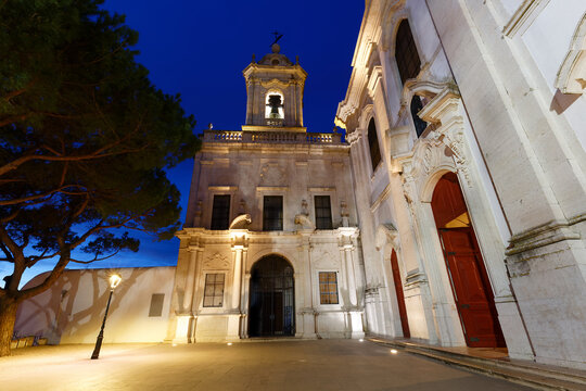 Breathtaking night view of an illuminated Baroque church in Lisbon, Portugal.