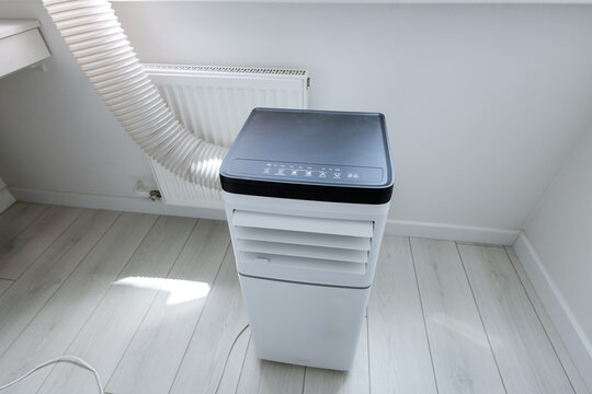 High-angle view of smart mobile monoblock air conditioner unit with electronic control panel and led icons